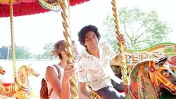 Couple riding carousel at amusement park Stock Footage