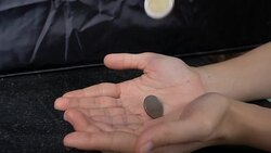 Super Slow-Motion: Coin Falling In Hand Stock Footage