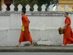 WS Monks walking along sidewalk / Luang Prabang, Laos Stock Footage