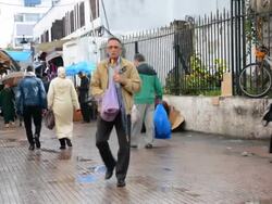 Rabat Morocco main medina locals walking in market after rain Stock Footage