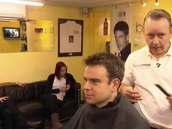 Man getting haircut in barbers chair News Clip