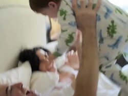 Parents and baby son having lie in in bed Stock Footage