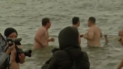 Swimmers take to the icy water in traditional New Year's dip News Clip