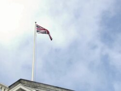 WS POV  Union Jack flying against sky / Trafalgar Square, London, England Stock Footage