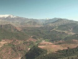 WS PAN View of atlas mountain range with green valley / near Marrakech, Marrakech, Morocco  Stock Footage