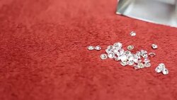 Zircon, Diamonds on red surface sorting Stock Footage