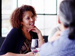 MS smiling woman sitting laughing with friends after meal at dinner party Stock Footage