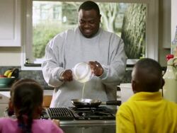 MS Dad scrambling and cooking eggs while  Daughter and son watching / Dallas, Texas, USA Stock Footage