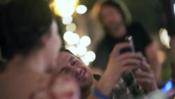 Young couple pose for smartphone selfies in colorful Austin bar Stock Footage