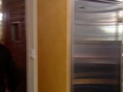 MS, PAN, People discussing in lunch room, man leaving, pouring water from water cooler in corridor Stock Footage