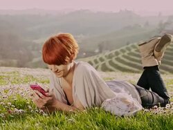 DS Woman typing sms in the grass Stock Footage