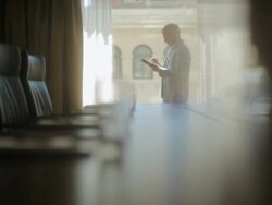 MS PAN Man working on ipad in meeting room / Seattle, WA, United States Stock Footage