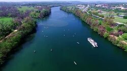 Flying over the Middle of Lake Aerial View Austin Texas Colorado River Fun Spring water activities with kayakers and Party Boat during SXSW Spring Break 2016 Stock Footage