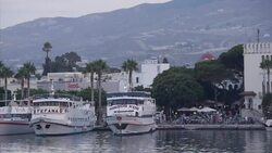 Tourists in Kos harbour area and yachts moored News Clip