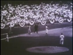 Fans cheer as Jackie Robinson steals home during the 1955 World Series in which the Brooklyn Dodgers defeated the New York Yankees. News Clip