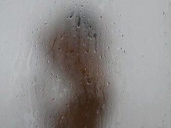 Women behind frosted glass shower Stock Footage