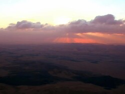 sunrise and runing clouds over vulcanic hills in ramon crater Stock Footage