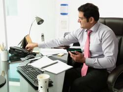 Businessman working on a mobile phone  Stock Footage