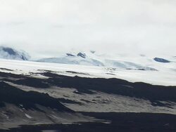 WS AERIAL View of snowy mountain range with lava features / Iceland Stock Footage