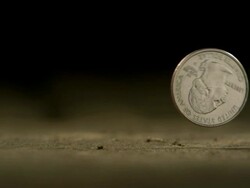 High Speed American Quarter dollar falls on to surface and bounces away Stock Footage