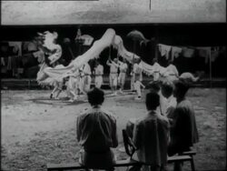 Chinese young men in Western white clothes perform a dragon dance Stock Footage