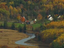 WS ARIEAL View of Houses around wooded area and autumn color at islands  / Maine, United States Stock Footage
