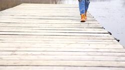Woman Walking on Wooden Dock Stock Footage