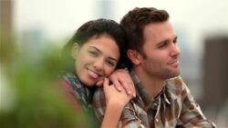 New York couple in love on Brooklyn rooftop, girl smiles at camera as guy looks out over skyline (dolly-shot) Stock Footage