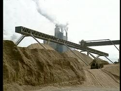WA View of factory, across masses of woodchip stockpiles Stock Footage