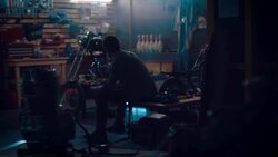 Man sitting in motorcycle workshop drinking coffe Stock Footage