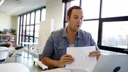 Architect showing sketch map in laptop video conferencing Stock Footage