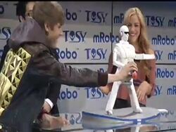 Pop singer Justin Bieber unveiled a state-of-the-art speaker that doubles as a dancing robot at the 2012 Consumer Electronics Show on Wednesday.  The toy is called mRobo Ultra Bass, it's expected to launch this fall and retail for about $200. News Clip