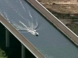 MS AERIAL PAN ZI View of boat moving in canal / Walloon Region, Belgium Stock Footage