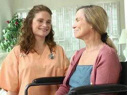 Nurse with Wheelchair Bound Woman in Home Stock Footage
