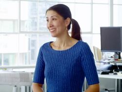 MS portrait of smiling businesswoman standing at office workstation Stock Footage