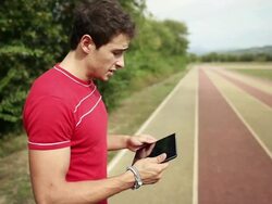 Personal trainer following schedule on tablet Stock Footage