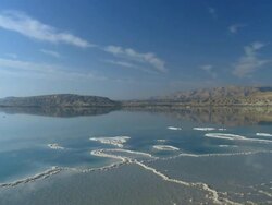 WS T/L View of sky moving over dead sea salt pans with sky reflection / Ein Bokek, Judea Desert, Israel Stock Footage