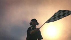 Stock car race official waves checkered flag Stock Footage