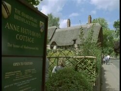 Thatched Tudor Cottage, Stratford-upon-Avon - information sign in foreground, tourists outside Anne Hathaway's house (wife of Shakespeare) Stock Footage