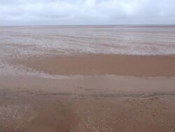 Low aerial across Heacham Beach at low tide Stock Footage