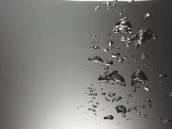 CU SLO MO Shot of small cluster of bubbles in dark tank / United Kingdom Stock Footage
