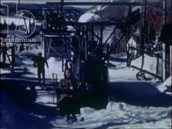 Skiers leave the lodge, ride the ski lifts and head down the slopes of the Laurentian Mountains in Quebec, 1930s Stock Footage