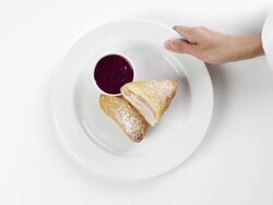 CU Woman hand entering setting down round white plate with chicken cordon bleu sandwich / Omaha, Nebraska, United States Stock Footage