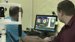 Optometrist explains something to patient after examination Stock Footage