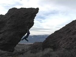 Climber ascending large boulder Stock Footage