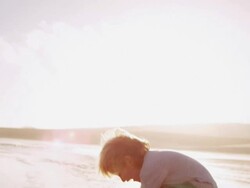 Child walking on beach Stock Footage