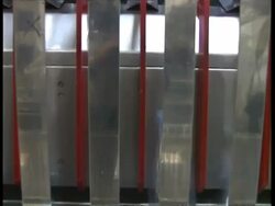 MCU tilt down and up again, Empty bottles being flipped into position at water bottling factory Stock Footage