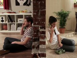 WS Split screen showing couple trying to dial each others at same time  / Berlin, Germany Stock Footage