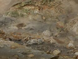 MS Water bubbling from geothermal hot spot surrounded by orange rocks and steam in Krysuvik Geothermal area / Reykjanes peninsula, Iceland        Stock Footage