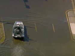 Sept. 11, 2005 aerial people in airboats on flooded street in wake of Hurricane Katrina/ New Orleans Stock Footage